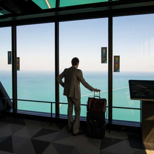 A man with a suitcase waiting at the airport