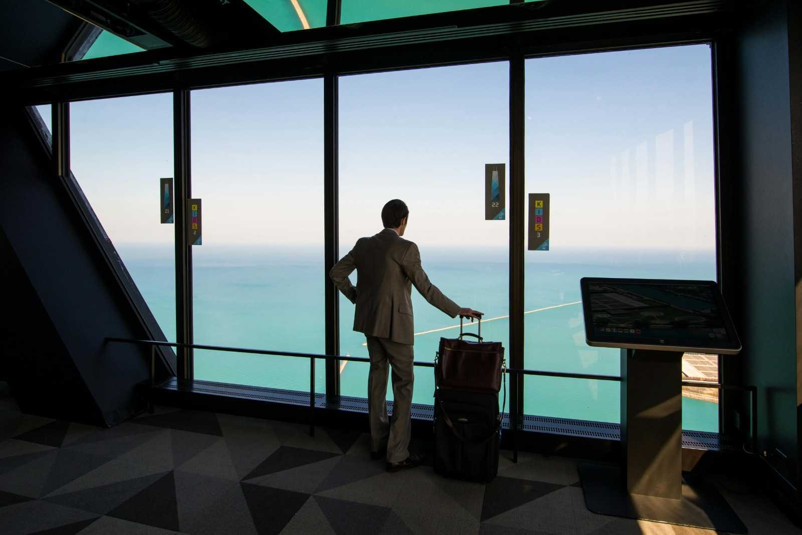 A man with a suitcase waiting at the airport